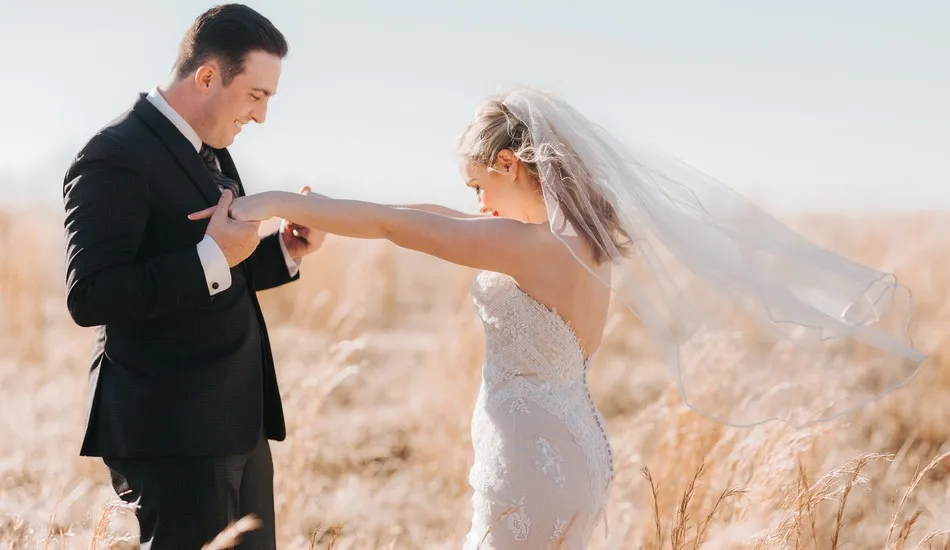 Gallery image of bride and groom in field
