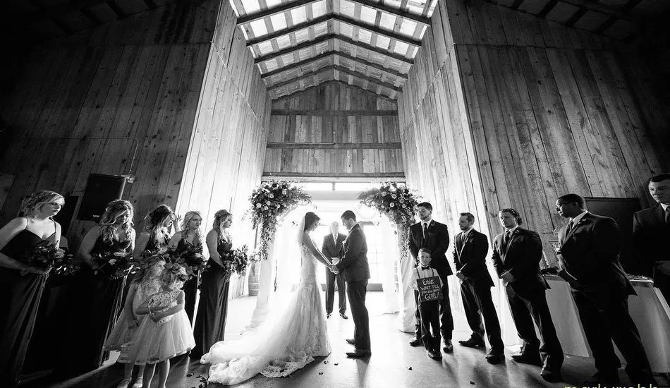 Gallery image of wedding ceremony in barn