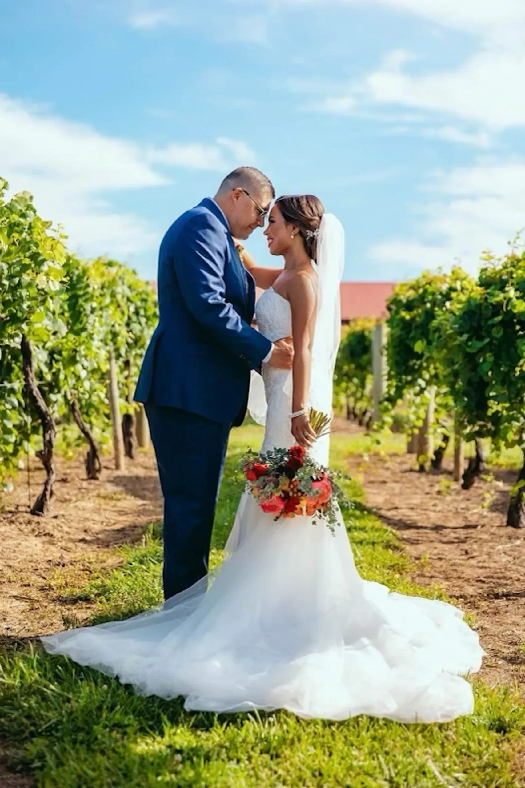 Gallery image of bride and groom in vineyard
